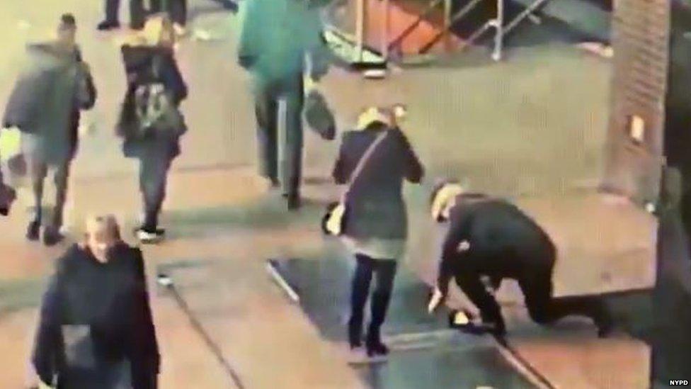 A man trying to retrieve a ring from a grate