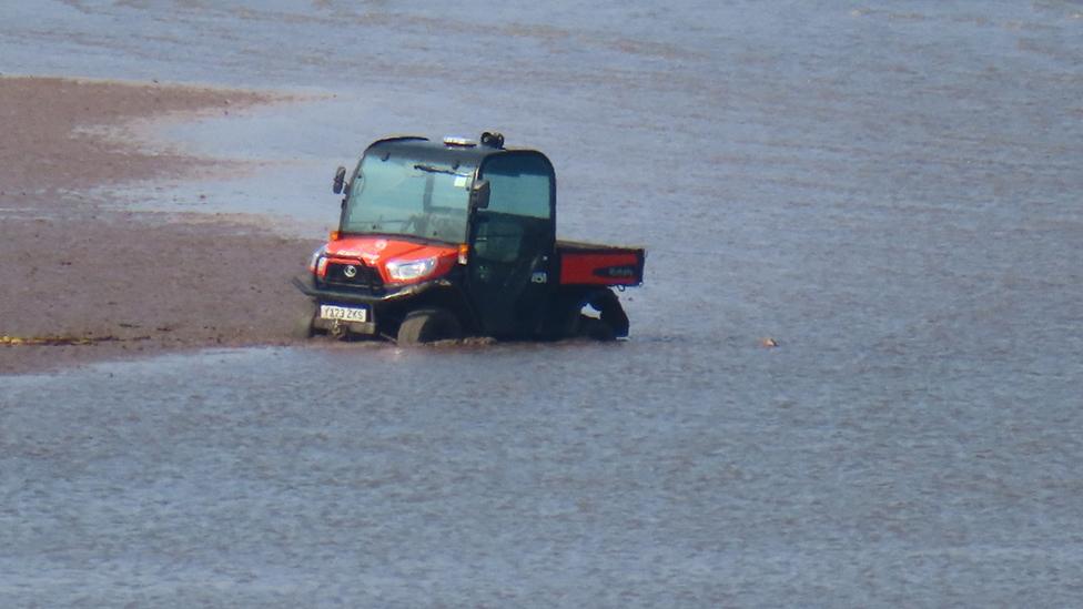 Buggy trapped in mud on beach