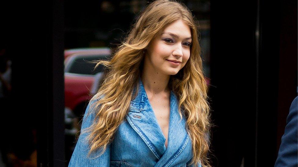 Gigi Hadid smiles for paparazzi