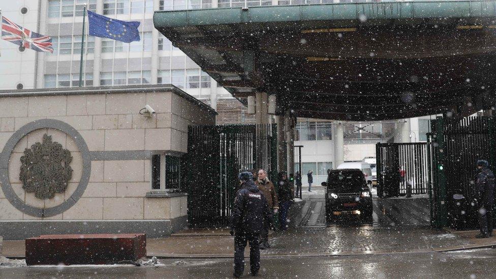 A convoy of vehicles leaves the British Embassy in Moscow