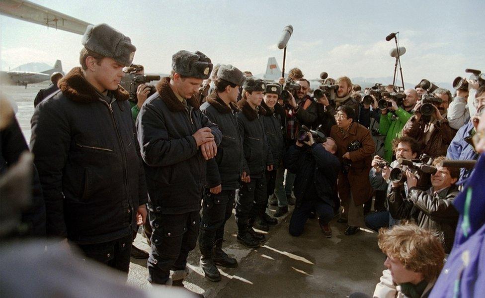 Red Army soldiers surrounded by foreign press wait at Kabul airport in February 1989, during the Soviet Army's withdrawal from Afghanistan.