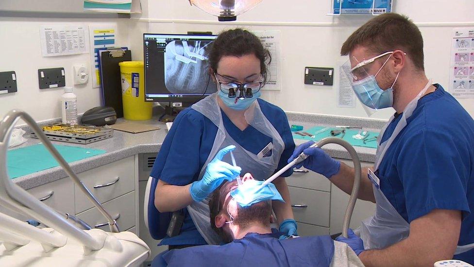 student dentists with patient