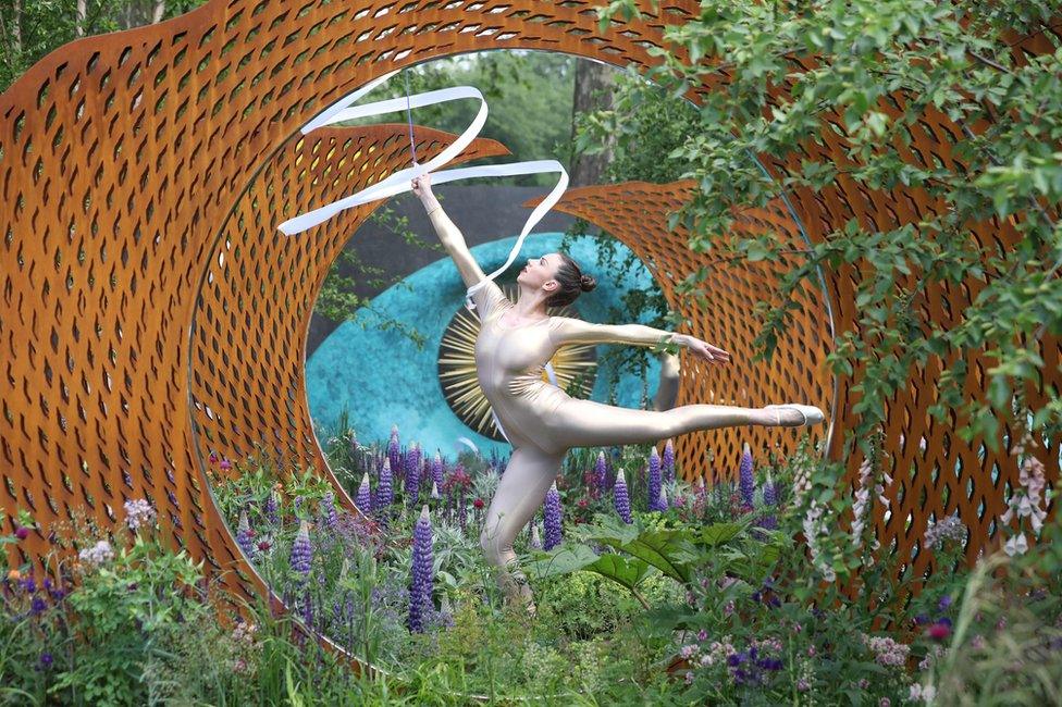 A dancer performs in the David Harber and Savills Garden at the 2018 Chelsea Flower Show