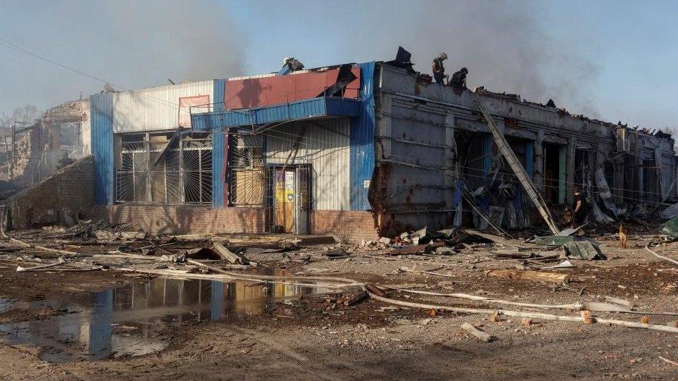 Rescuers work at the site of Russian air strikes in the village of Lyptsi, Kharkiv region, 10 April 2024.