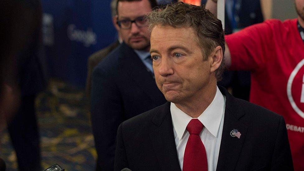 Rand Paul talks to reporters after a debate in Iowa.