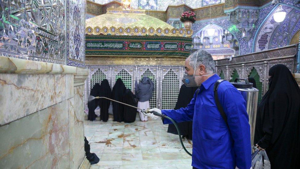 A worker disinfects the shrine of Hazrat Masumeh in Qom, Iran (25 February 2020)