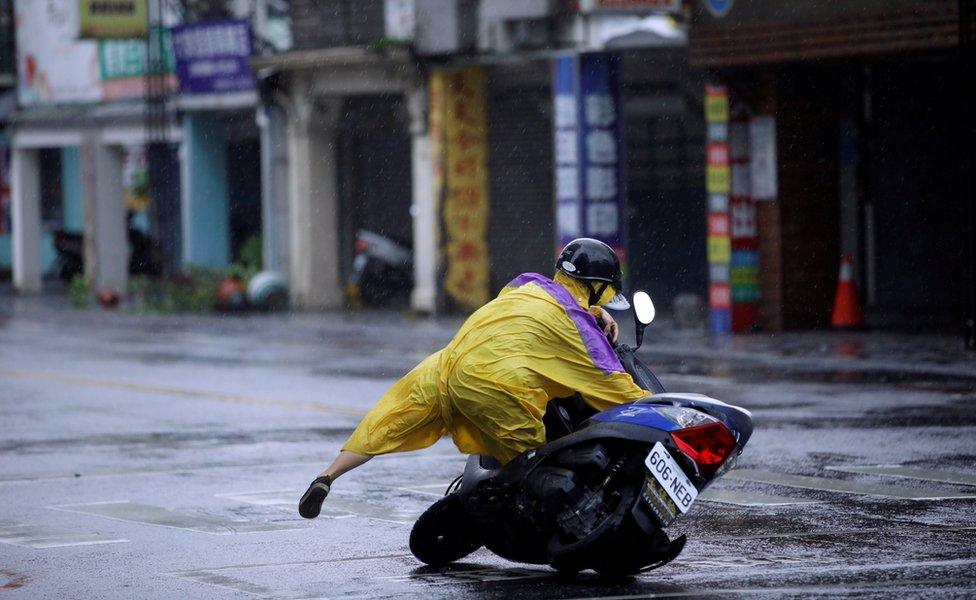 A motorcyclist falls off their bike as Typhoon Megi hits Hualien, eastern Taiwan, 27 September 2016.