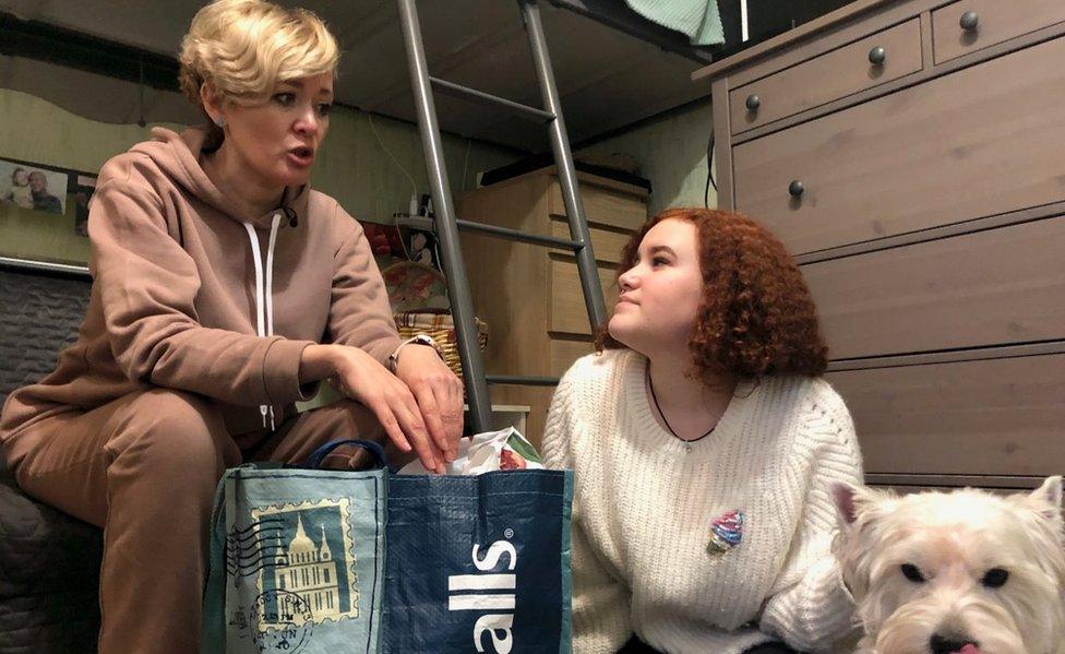 Anastasia Shevchenko prepares a bag for prison with her daughter