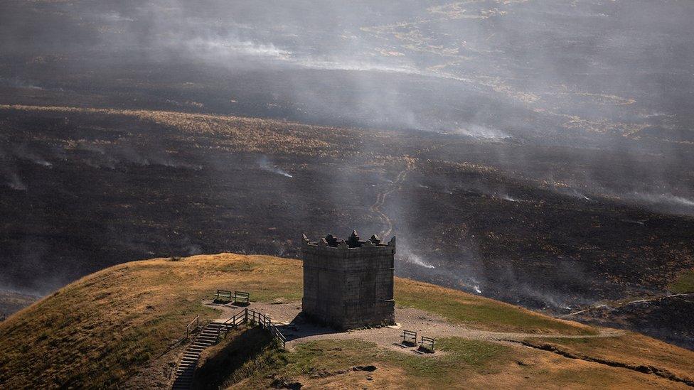 building on hill overlooking moorland