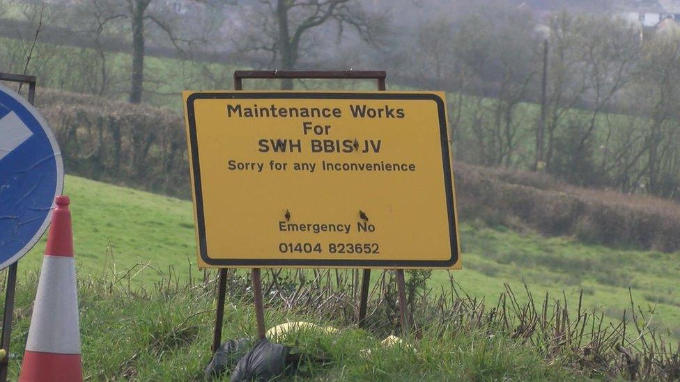Maintenance sign in front of a field