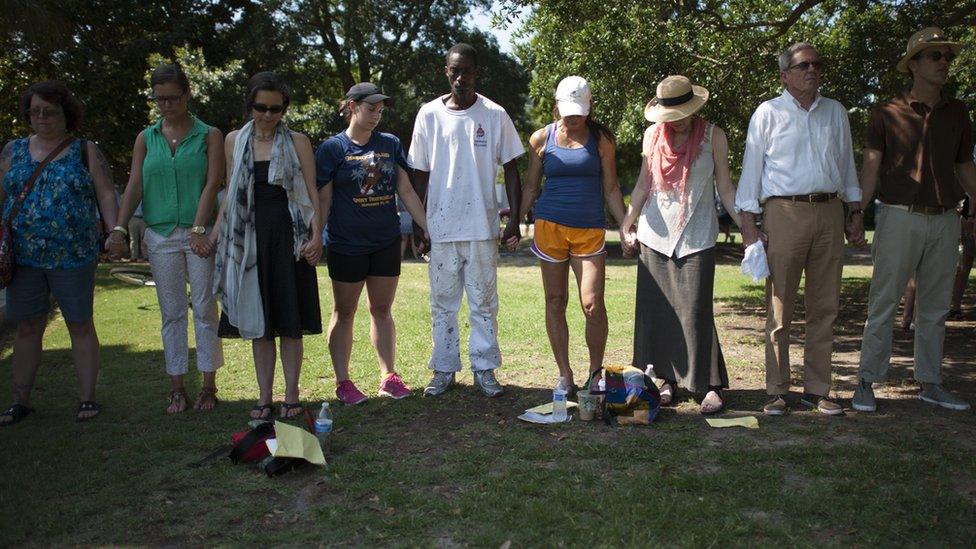 2015-06-21. People gathered for a prayer service in Marion Park, Charleston on Sunday morning. Colm O'Molloy for BBC News.