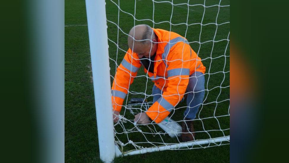 Ian Darler mending a net