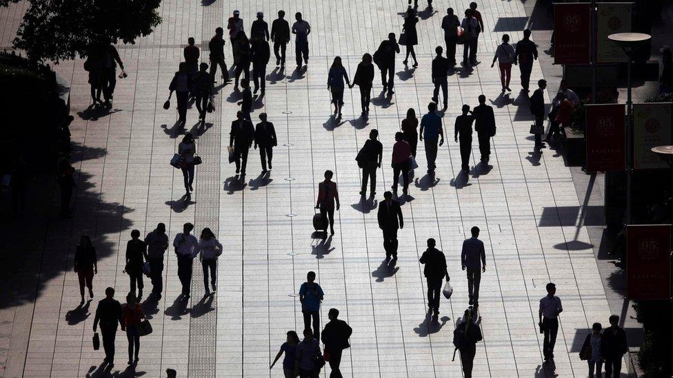 Pedestrians in central Shanghai (file photo - April 2013)
