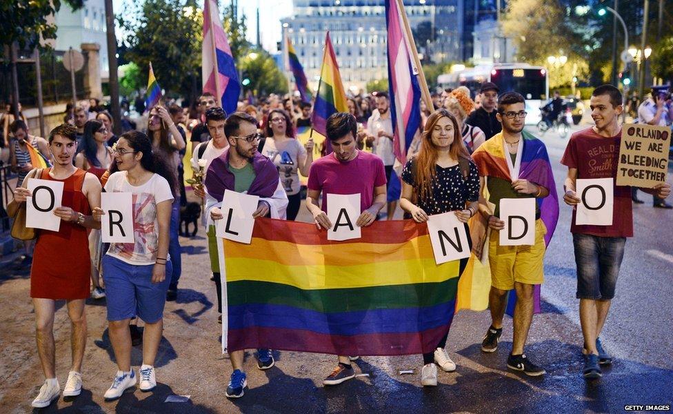 People hold a rainbow flag in June, 2016 in Athens, Greece, to pay tribute for the victims of the Orlando shooting in Florida. Forty-nine people were killed and 53 others wounded. Rallies took place across the world to remember them.