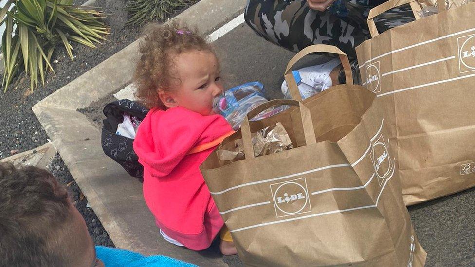 Child by bags of food