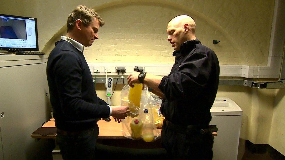 Tom Heaton with illicit alcohol seized from inmates