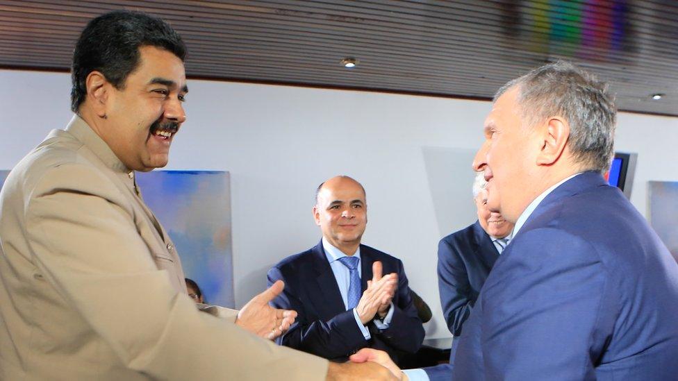 Venezuelan President Nicolás Maduro (L) greeting the head of the Russian state-owned oil giant Rosneft, Igor Sechin