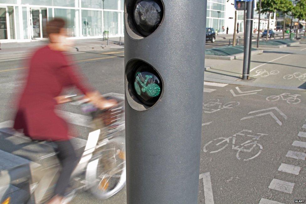 Cyclist in Paris at green light