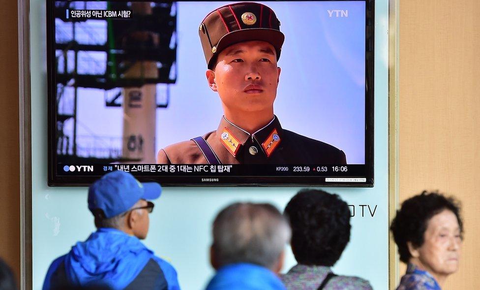 People watch a news report at a railway station in Seoul on 15 September 2015, on the confirmation from North Korea that the nuclear reactor seen as the country's main source of weapons-grade plutonium had resumed normal operations