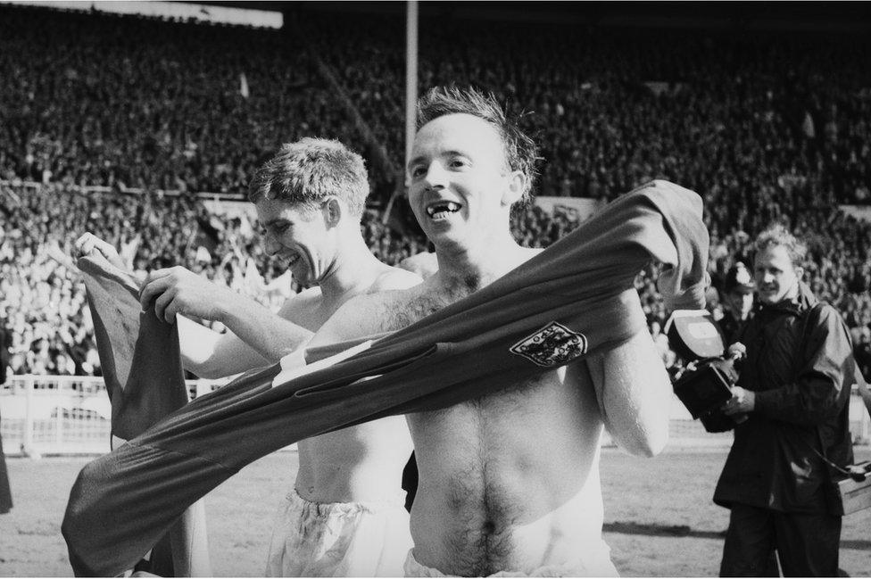 Nobby Stiles (right) swaps his shirt with fellow England player Alan Ball on the Wembley pitch after the match