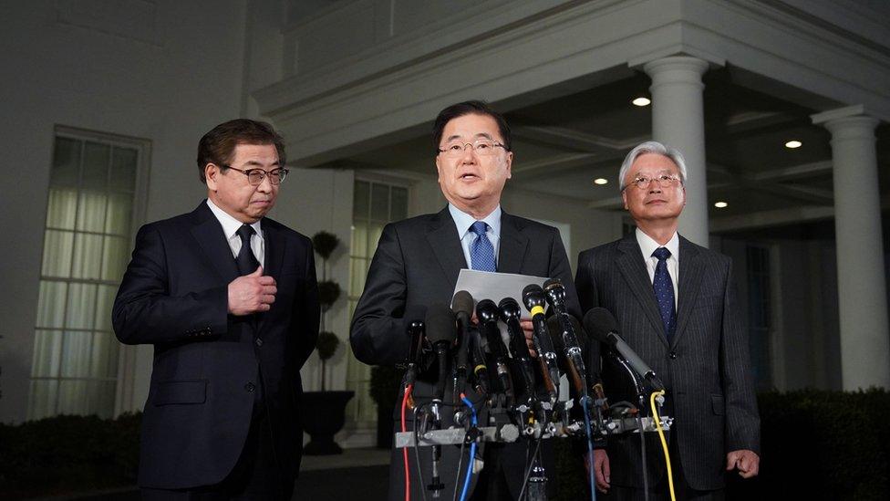 South Korean National Security Advisor Chung Eui-yong (C), flanked by South Korea National Intelligence Service chief Suh Hoon (L) and South Korea's ambassador to the United States Cho Yoon-je (2nd-R), announcing North Korean leader Kim Jong Un has offered to meet US President Donald Trump.