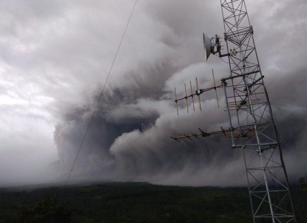 A picture from the Indonesian National Board for Disaster Management shows ash rolling over the landscape