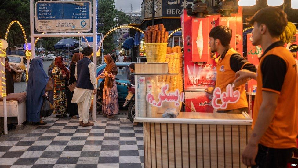 A family arriving at an ice cream shop in Kabul