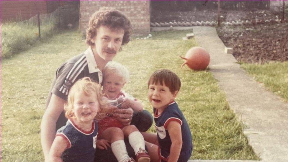 Claire Holland with her siblings and father as a child