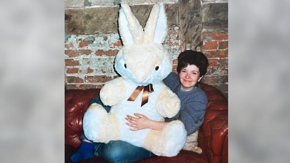 A women with brown hair and a large bunny