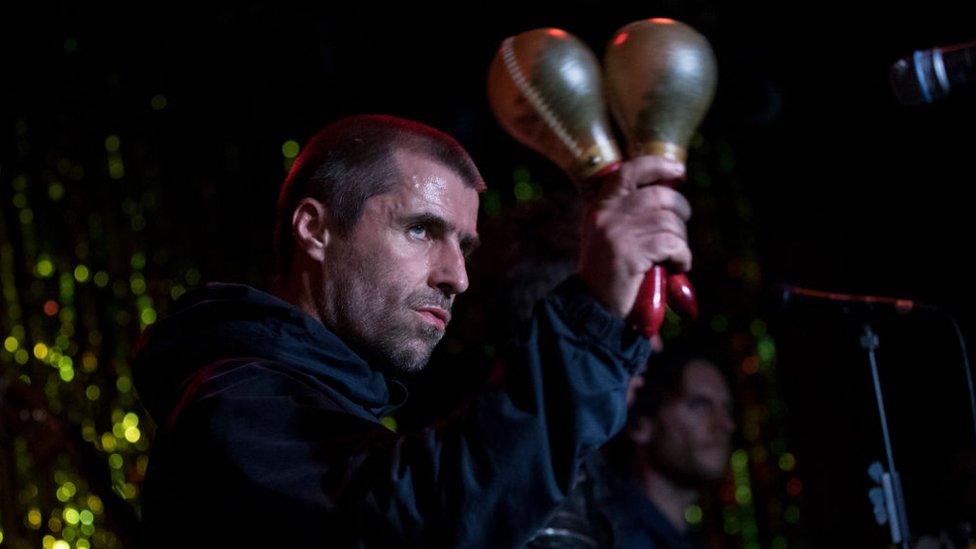 Liam Gallagher performing on stage