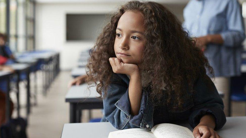 Girl looking out of the classroom window