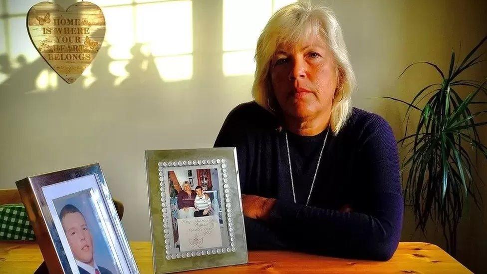 Melanie Leahy alongside a picture of her late son, Matthew