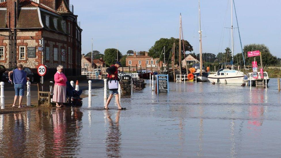 Man walking in flood in Blakeney