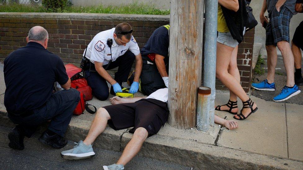 Medics revive a man who was found unresponsive and not breathing after an opioid overdose on a sidewalk in a Boston suburb