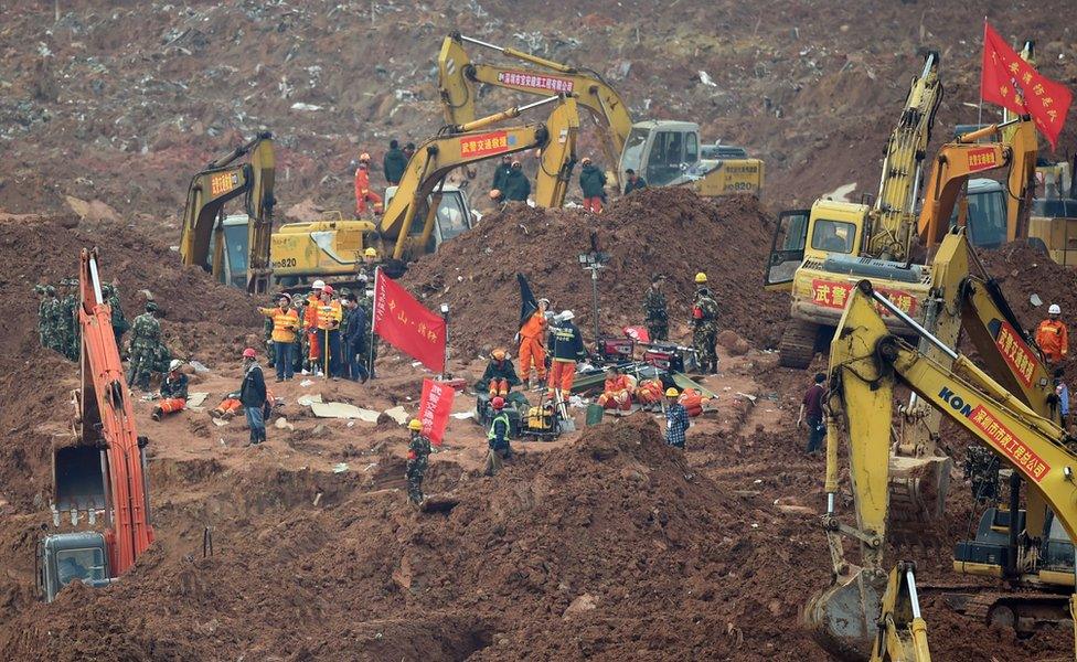 Rescue workers look for survivors after a landslide hit an industrial park in Shenzhen, south China's Guangdong province on 22 December 2015