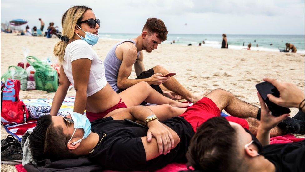 People relax on Miami Beach