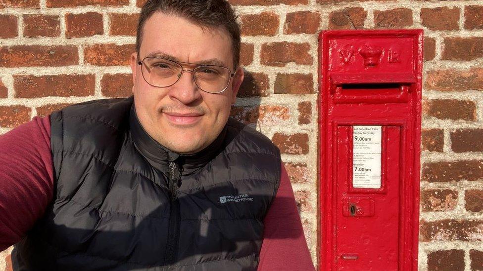 Adam Šapić with a Victorian wall post box