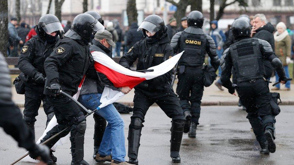 police officers detain protester