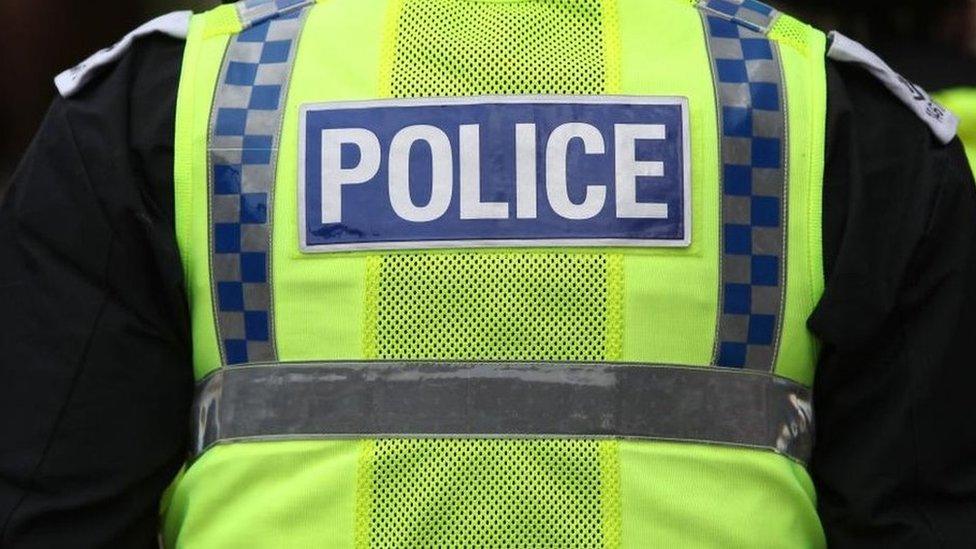 File photo shows the back of an officer from the Metropolitan Police. He is wearing a high visibility jacket with the word 'POLICE' in large letter across the back.