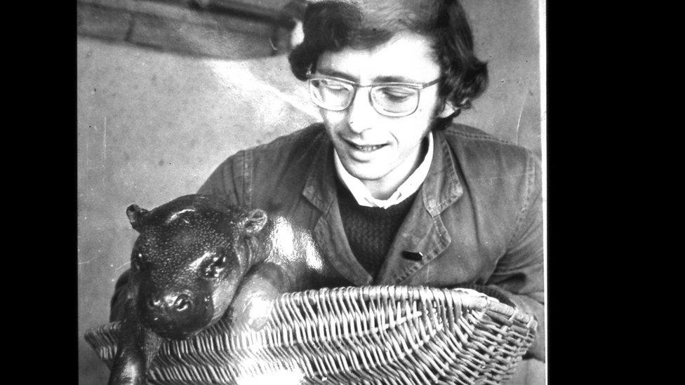 John Partridge with a baby hippopotamus at Bristol Zoo