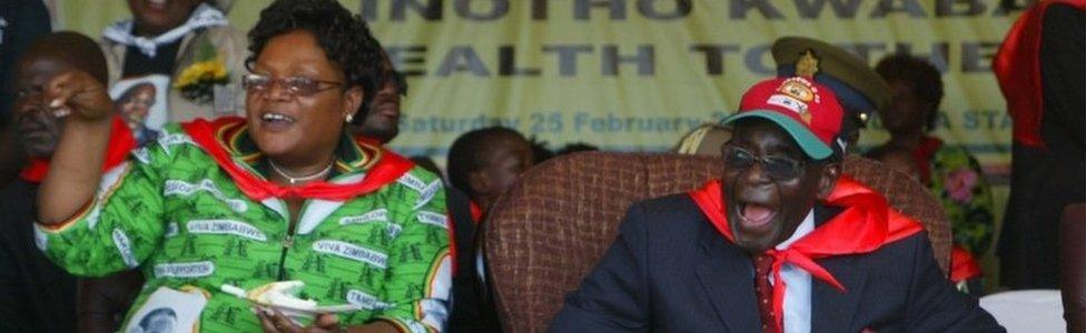 This file photo taken on February 25, 2012 shows Robert Mugabe (R) and Joyce Mujuru attending a rally in Mutare