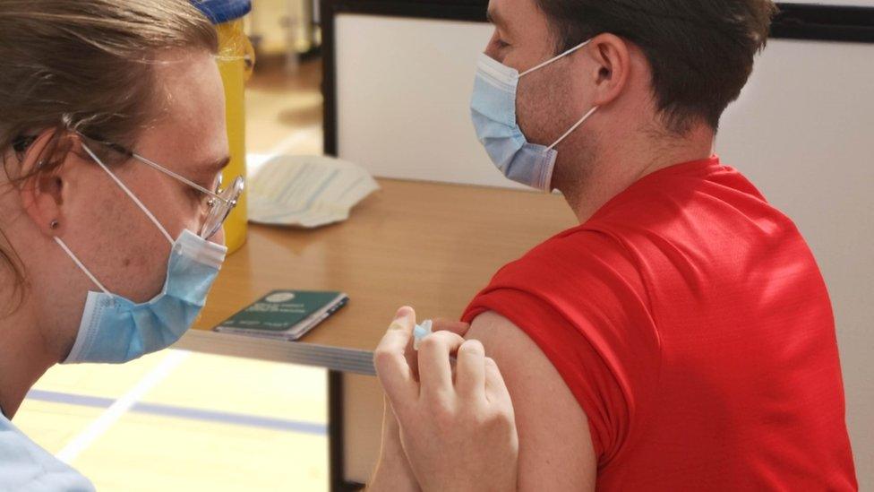 Sam Jamieson receives his covid-19 vaccine from vaccinator Steven Dawson at the Alistair McCoist Complex vaccination centre in East Kilbride