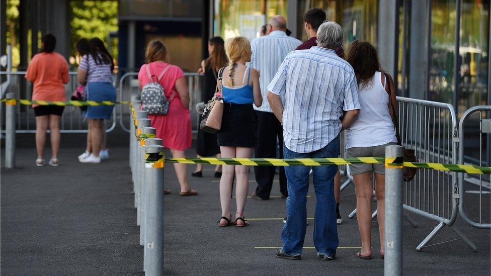 Shoppers-queue-to-go-inside.