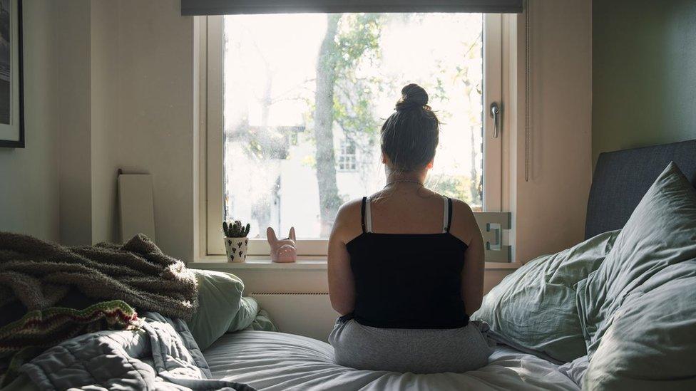 A girl sitting on a bed
