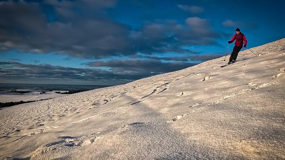 Chris skiing down a mountain