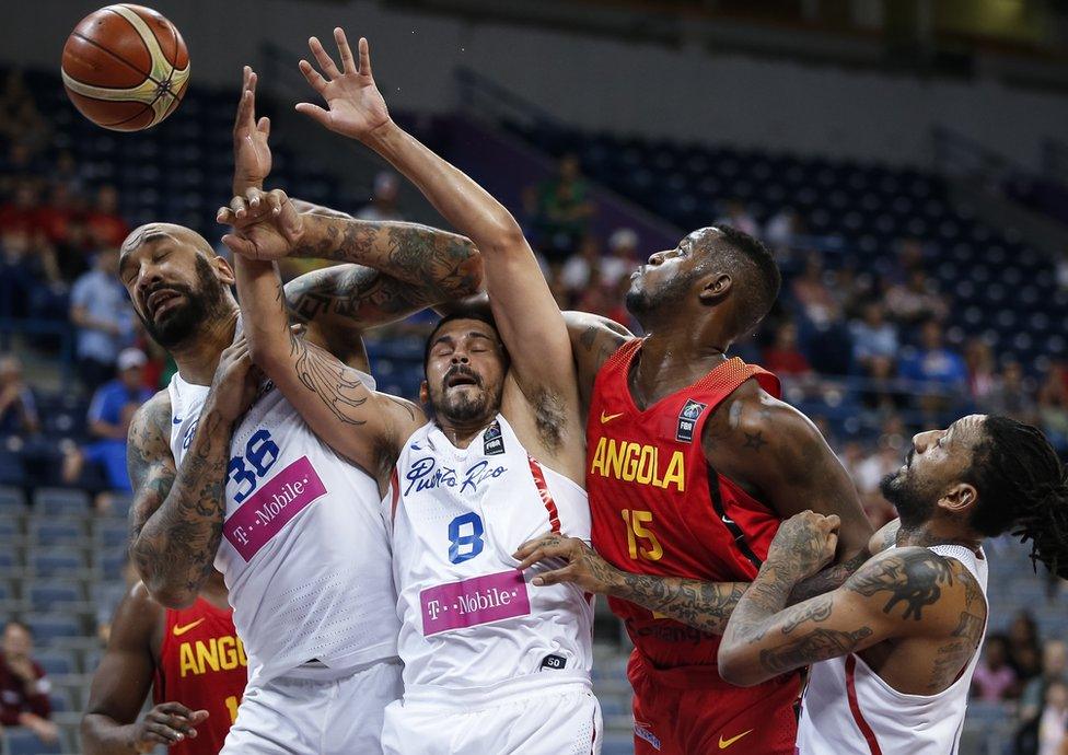 JULY 05: Reggie Moore (R) of Angola competes for the ball against Angel Vassallo Colon (C) and Peter Ramos (L) of Puerto Rico during the 2016 FIBA World Olympic Qualifying basketball Group A match between Puerto Rico and Angola