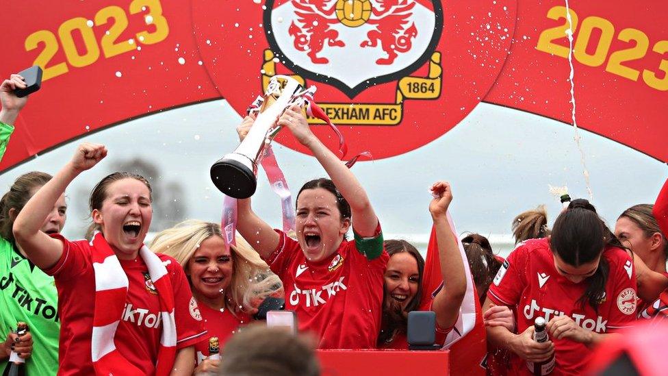 Wrexham players celebrate with the Adran North trophy