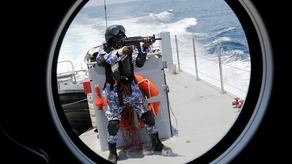 A member of the Ivory Coast Navy takes part in a multinational naval exercise off the coast of Abidjan, Ivory Coast
