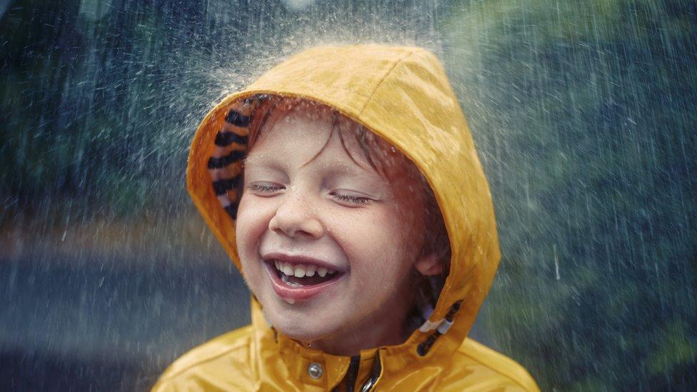 Boy in yellow raincoat