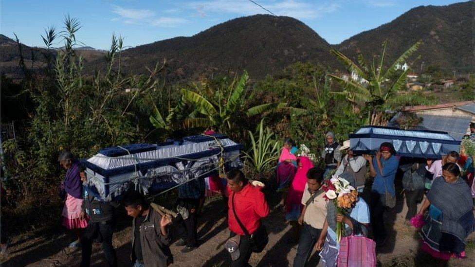 People carry the coffins of five of the 10 musicians who were ambushed in Alcozacan, Mexico, January 29, 2020.